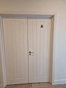 a door with a alphabet on it in a room at Spacious single bedrooms in central location with parking in New Barnet