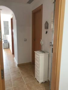 a hallway with a white dresser and a door at MOJACAR WITH POOL, BEACH AND GoLF in Mojácar