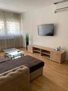 a living room with a flat screen tv on a wall at Apartman Atos stan na dan in Prijedor