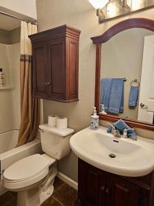 a bathroom with a toilet and a sink and a mirror at Bay View, Best Area, No Stairs, WD, 2 Baths, 2 Bedrooms, Balcony, View, 925sf in Tacoma