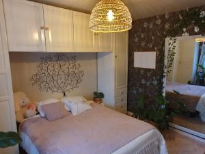 een slaapkamer met een bed met een teddybeer erop bij Room in BB - Nathalies home - 2 Bedrooms Breakfast in Viry-Châtillon