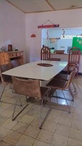 a dining table and chairs in a kitchen at Casa de playa en Dibulla in Dibulla