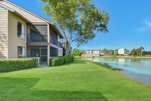 a apartment building with a lawn next to a river at 274 Moss Oak Lane in Saint Simons Island