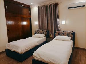 Кровать или кровати в номере لاكاسا للشقق السكنية /Lacasa Apartments
