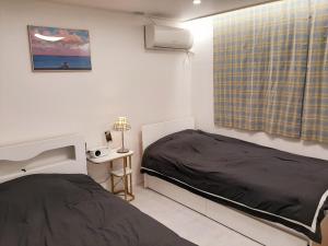 Säng eller sängar i ett rum på New Hongdae apartment