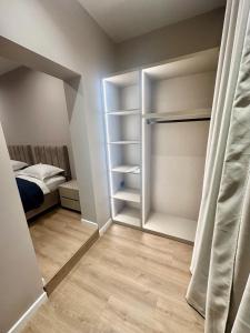 a bedroom with a closet with a bed in it at Venis Hotel in Tirana