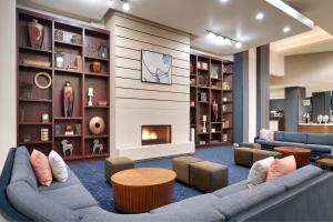 a living room with couches and a fireplace at Courtyard by Marriott Ogden in Ogden