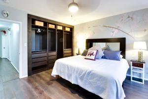 a bedroom with a large bed and a tv at Unique DC Row House Near Historic H Street! in Washington