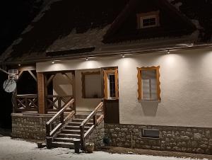 a house with stairs and windows at night at Villa Lupus - apartament z prywatną sauną in Szklarska Poręba