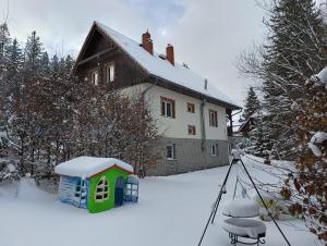 a picture of a house in the snow with a camera at Villa Lupus - apartament z prywatną sauną in Szklarska Poręba