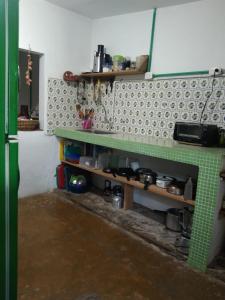 a kitchen with a green and white tiled wall at Casa de playa en Dibulla in Dibulla +54 photos
