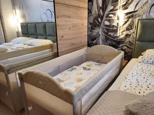 a hospital room with two beds and a crib at Apartman Restart Zlatibor in Zlatibor