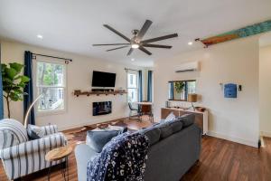 a living room with a couch and a ceiling fan at Judy's Nest at the Wessels-Boyd House. in Savannah