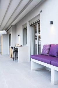 a purple couch in a room with a table at Brand new Penthouse with Terrace in Athens