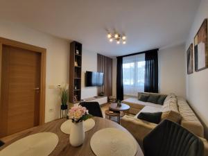 a living room with a couch and a table at Apartman Restart Zlatibor in Zlatibor