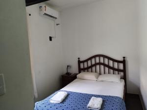 1 dormitorio con 1 cama con 2 toallas en Casa São Sebastião, en São Sebastião