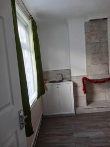 a small bathroom with a sink and a shower at Amarillys Guest House in Preston