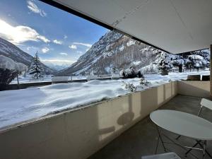 a balcony with a view of a snow covered mountain at Cozy loft for 2 near zermatt in Täsch