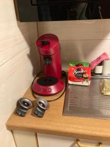 a red blender sitting on top of a wooden table at Gemütliche Ferienwohnung in Sankt Blasien in St. Blasien