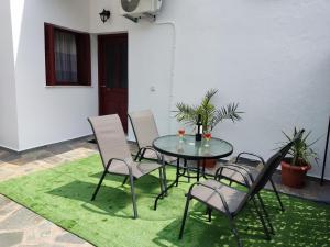 a table and chairs on a green rug at Cozy Mountain View in Glóssa +18 photos