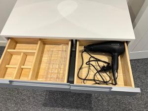 a drawer in a desk with wires in it at Newly Renovated Apartment in Bicester