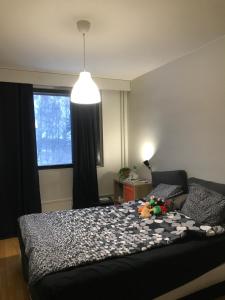 a bedroom with a bed and a large window at Room near Tripla Pasila in Helsinki