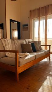 a wooden couch sitting in a living room at Kaia Beach House Boa Vista Front Sea View Apartments in Sal Rei