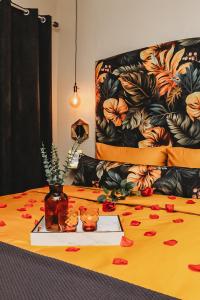 a bed with a table with flowers on it at Villa La'Vie in Witbank +38 photos