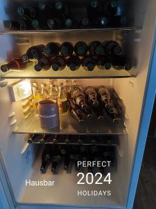 a refrigerator filled with lots of bottles of wine at Amtmannhaus Ferienunterkunft in Irdning