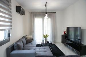 a living room with a couch and a television at PARIS Opulent Lifestyle in Drama