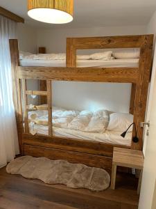 two bunk beds in a room with a lamp at Appartement Everest in Zermatt