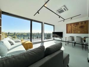 a living room with a couch and a large window at Danube Luxury Suite in Budapest