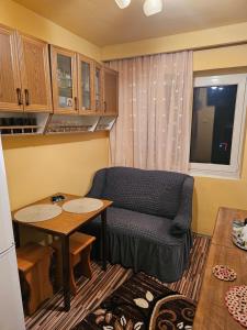 a living room with a couch and a table at Cazare Bailesti in Băileşti +6 photos