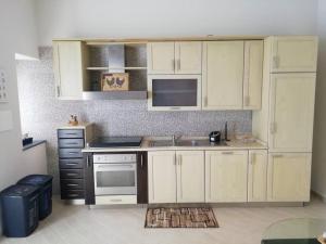 a kitchen with white cabinets and a sink at Casa Sambuco in Volla