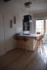 a kitchen with a counter and stools in a room at Residenza delle Farfalle in Padova
