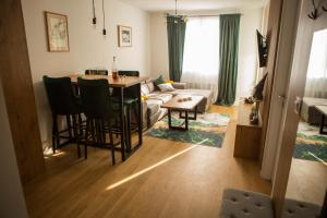 a living room with a table and a couch at Apartman Tanja Jahorina in Jahorina