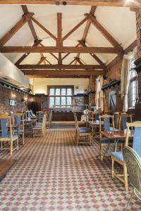 an empty room with tables and chairs in a building at Himley Country Hotel in Dudley