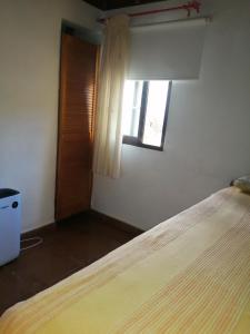 a bedroom with a large bed and a window at Casa La Rehoya in Puntallana