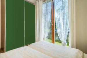 a bedroom with a bed and a large window at Ferienhaus Im Tobel in Deggenhausertal