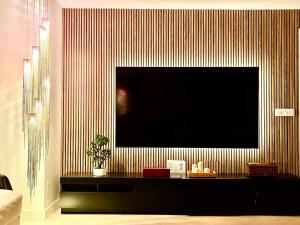 a living room with a large television on a wall at Cathedral Boutique by Lugo Collection in Lugo