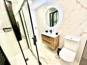 a bathroom with a toilet and a sink and a mirror at Cathedral Boutique by Lugo Collection in Lugo