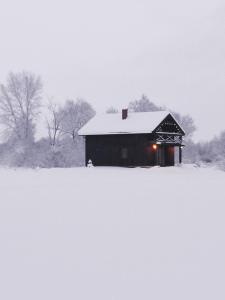 ルスネにあるNamelis Gluosnėの畑の雪に覆われた納屋