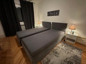 a bed in a living room with a couch at Layla's Home Free Parking in Sarajevo