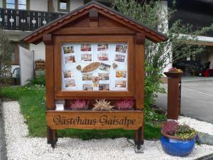 a sign for a christmas exchange in a garden at Gästehaus Gaisalpe in Fischen