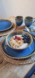 a plate of food with fruit on a table at Les petites chambres St Gervais in Saint-Gervais-les-Bains