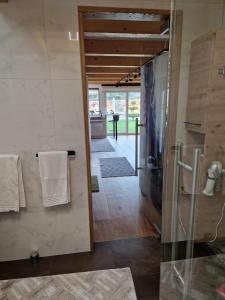 a bathroom with a shower and a glass door at FERIENHAUS A&C DELUXE AM SEE in Spielberg