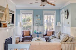 a living room with blue walls and a ceiling fan at Sandy Feet Retreat in Lincoln City