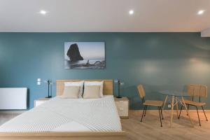 a bedroom with a large bed and a table at Rose, Appartement Confortable proche Metro in Montrouge