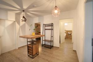 a dining room with a table and a chandelier at Zentrum Appartements Mörbisch in Mörbisch am See