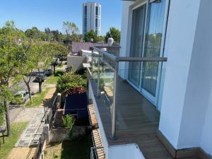 a balcony with glass railings and plants on a house at Tigre Urban Suites in Tigre